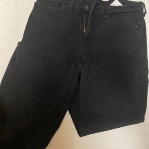 Faded black Levi’s 711 women’s jeans.